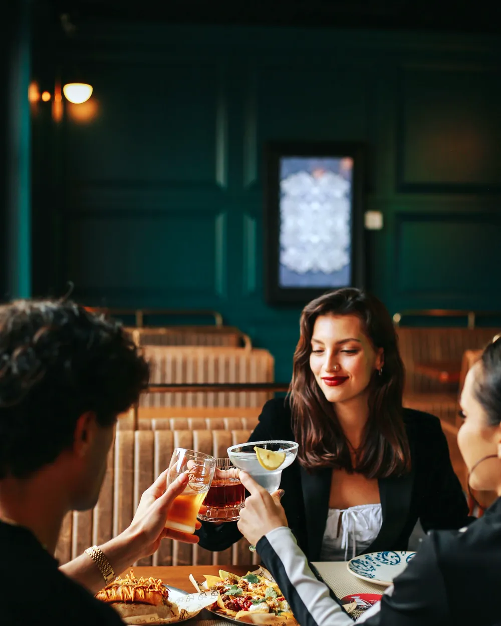 A group with cocktails at a bar table