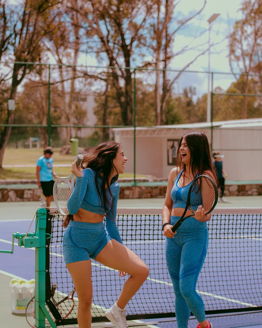 Two players talking at the net on a tennis court